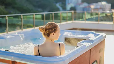 woman relaxing in-spa with perfect working jets after hot tub pump repair in san diego